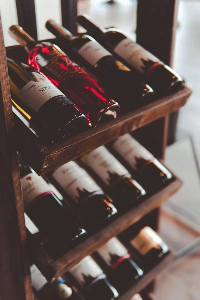 Wine bar OakBarrelHouse z butelkami wina i bursztynowym światłem